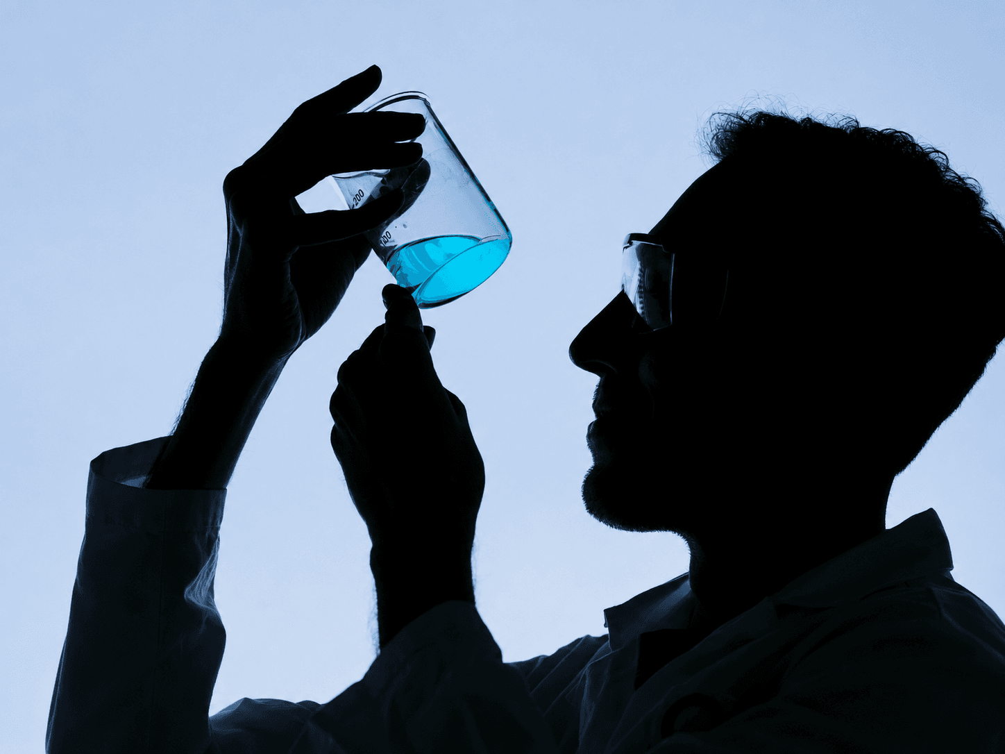 Pharmaceutical researcher examining a laboratory formulation